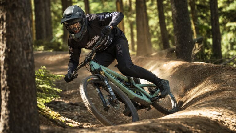 Mountain biker executing a perfect cornering technique on a bermed singletrack trail