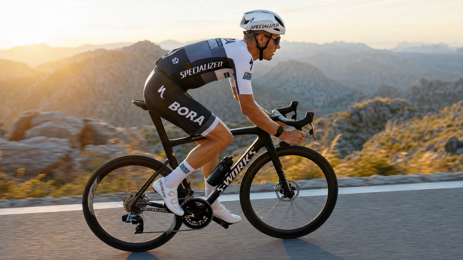 Professional road cyclist maintaining aerodynamic riding posture on mountain road