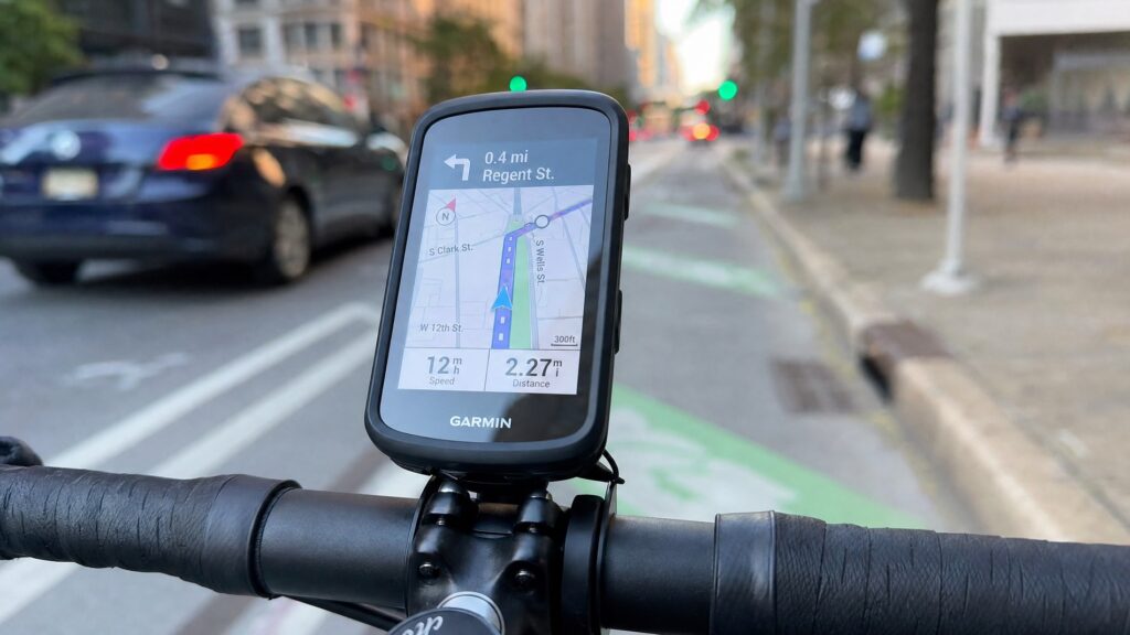 Close-up of a commuter cyclist's handlebar with a GPS computer showing a city cycling route map