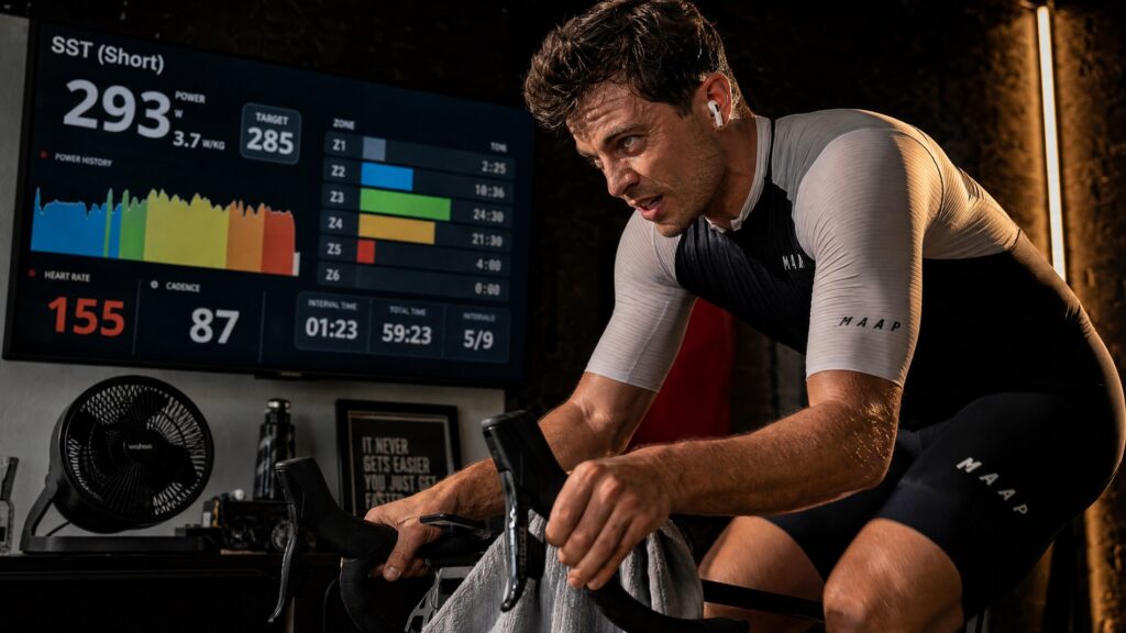 Focused cyclist performing sweet spot interval training on a smart indoor trainer