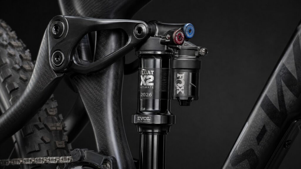 Modern bicycle rear air shock absorber mounted on a carbon fiber full-suspension mountain bike frame